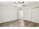 Spacious bedroom with ceiling fan and mirrored closet doors at 17461 Se 93Rd Retford Ter, The Villages, FL 32162