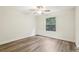 Well-lit bedroom with ceiling fan and wood-look flooring at 17461 Se 93Rd Retford Ter, The Villages, FL 32162