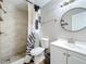 Clean bathroom with white vanity and patterned shower curtain at 1805 Jefferson Dr, Mount Dora, FL 32757