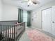 Charming bedroom with crib, window, and closet at 1805 Jefferson Dr, Mount Dora, FL 32757