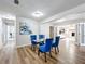 Bright dining room with blue chairs and a view into the living room at 1805 Jefferson Dr, Mount Dora, FL 32757