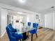 Bright dining room with glass table and blue velvet chairs at 1805 Jefferson Dr, Mount Dora, FL 32757