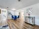 Dining area with glass table, blue velvet chairs, and mirrored buffet at 1805 Jefferson Dr, Mount Dora, FL 32757