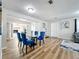 Bright dining room with glass table and blue velvet chairs at 1805 Jefferson Dr, Mount Dora, FL 32757