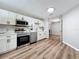 Modern kitchen with white cabinets and stainless steel appliances at 1805 Jefferson Dr, Mount Dora, FL 32757