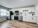 Modern kitchen with white cabinets and stainless steel appliances at 1805 Jefferson Dr, Mount Dora, FL 32757