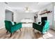 Living room with green armchairs and a white sofa at 1805 Jefferson Dr, Mount Dora, FL 32757