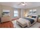 Comfortable bedroom with hardwood floors, a dresser, and a king-size bed at 21524 Queen Anne Ct, Leesburg, FL 34748