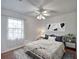 Serene bedroom with a metal bed frame and neutral-toned decor at 21524 Queen Anne Ct, Leesburg, FL 34748