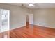 Spacious bedroom with hardwood floors and access to bathroom at 21524 Queen Anne Ct, Leesburg, FL 34748