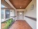 Covered entryway with tile flooring and a glass door at 21524 Queen Anne Ct, Leesburg, FL 34748