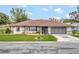 Single-story house with brown roof, screened porch, and driveway at 21524 Queen Anne Ct, Leesburg, FL 34748