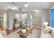 Bright living room features hardwood floors, a cozy seating area, and a view to the kitchen at 21524 Queen Anne Ct, Leesburg, FL 34748