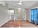 Living room with hardwood floors and glass shelving unit at 21524 Queen Anne Ct, Leesburg, FL 34748