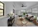 Relaxing sunroom with wicker furniture and large windows at 21524 Queen Anne Ct, Leesburg, FL 34748