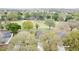 Aerial view of homes, golf course, and mature trees in the community at 2209 Stonebridge Way, Clermont, FL 34711