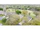 Aerial view of homes in a lush golf course community with mature trees and green fairways at 2209 Stonebridge Way, Clermont, FL 34711