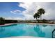 Inviting community pool with lounge chairs and palm trees, perfect for relaxation and recreation at 2209 Stonebridge Way, Clermont, FL 34711