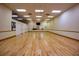 Large fitness room with hardwood floors, mirrored walls, and ceiling fans, offering ample space for exercise at 2209 Stonebridge Way, Clermont, FL 34711