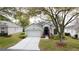 Charming single-story home with well-manicured landscaping and attached two-car garage at 2209 Stonebridge Way, Clermont, FL 34711