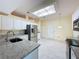 Bright kitchen with granite countertops, stainless steel appliances, and recessed lighting at 2209 Stonebridge Way, Clermont, FL 34711