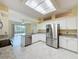 Modern kitchen featuring stainless appliances, granite countertops, and barstool seating area at 2209 Stonebridge Way, Clermont, FL 34711