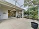 Spacious screened lanai featuring a seating area, ceiling fan, and view of the yard at 2209 Stonebridge Way, Clermont, FL 34711