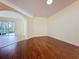 Living room features hardwood flooring and views of the outdoor living space at 2209 Stonebridge Way, Clermont, FL 34711