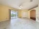 Bright living room featuring tile flooring, ceiling fan, and sliding glass doors to the lanai at 2209 Stonebridge Way, Clermont, FL 34711