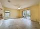 Open concept living room featuring tile flooring and sliding glass door leading to the outdoor lanai at 2209 Stonebridge Way, Clermont, FL 34711