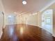 Bright open-concept living space with hardwood floors and a doorway leading to the entryway at 2209 Stonebridge Way, Clermont, FL 34711