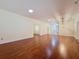 Open living room with hardwood floors, recessed lighting, and seamless flow to the foyer and dining area at 2209 Stonebridge Way, Clermont, FL 34711