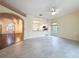 Bright living room featuring tile flooring and a view into the kitchen and dining area at 2209 Stonebridge Way, Clermont, FL 34711