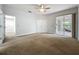 Main bedroom featuring neutral carpet, an outdoor lanai entrance and ensuite bathroom at 2209 Stonebridge Way, Clermont, FL 34711