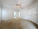 Spacious main bedroom with a ceiling fan and neutral tones, creating a relaxing atmosphere at 2209 Stonebridge Way, Clermont, FL 34711