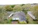 Aerial view of the home with a screened lanai and lush landscaping at 2209 Stonebridge Way, Clermont, FL 34711