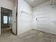 Spacious walk-in closet featuring carpeted floors and white metal shelving for optimal storage solutions at 2209 Stonebridge Way, Clermont, FL 34711