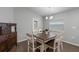 Bright dining area with a rustic wooden table and white chairs at 2311 Sunset Way, Davenport, FL 33837