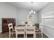 Bright dining area with a rustic wooden table and white chairs at 2311 Sunset Way, Davenport, FL 33837