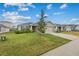 Single-story house with a two-car garage and front yard at 2311 Sunset Way, Davenport, FL 33837