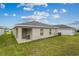 Rear view of house showing patio and yard at 2311 Sunset Way, Davenport, FL 33837