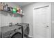 Convenient laundry room with washer, dryer, and shelving at 2311 Sunset Way, Davenport, FL 33837