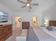 King size bed, dresser, and access to bathroom at 2597 Mariotta Rdg, Clermont, FL 34715