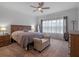 Main bedroom with large bed and sitting area at 2597 Mariotta Rdg, Clermont, FL 34715