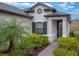 House exterior with gray siding, dark shutters, and a front door at 2597 Mariotta Rdg, Clermont, FL 34715