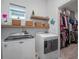 Bright laundry room with washer, dryer and closet at 2597 Mariotta Rdg, Clermont, FL 34715