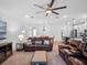 Relaxing living area with leather sofas, a large TV and ceiling fan at 2597 Mariotta Rdg, Clermont, FL 34715