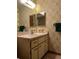 Small bathroom with a vanity, toilet and patterned wallpaper at 2620 Janet St, Kissimmee, FL 34741