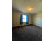 Bright bedroom with carpeted floors and blue curtains at 2620 Janet St, Kissimmee, FL 34741