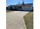 Front view of a single-story home with a long driveway and grassy yard at 2620 Janet St, Kissimmee, FL 34741